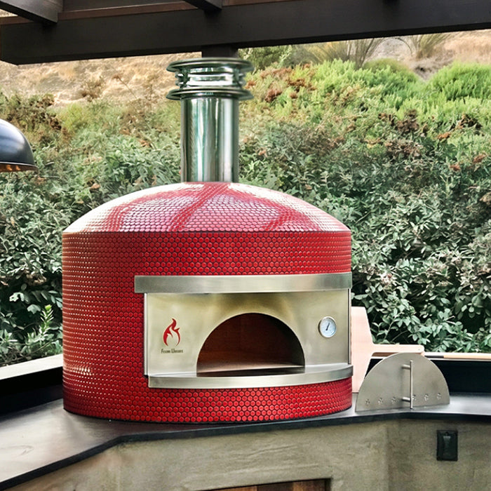 Forno Classico Napoli pizza oven on a patio with greenery in the background