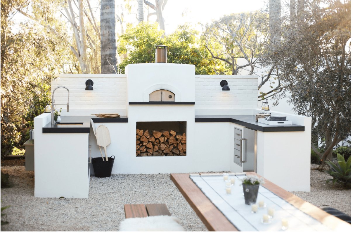 Fiamma square brick pizza oven on the garden surrounded with trees