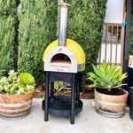 Forno Classico Piccolo 65 pizza oven with plants in the foreground