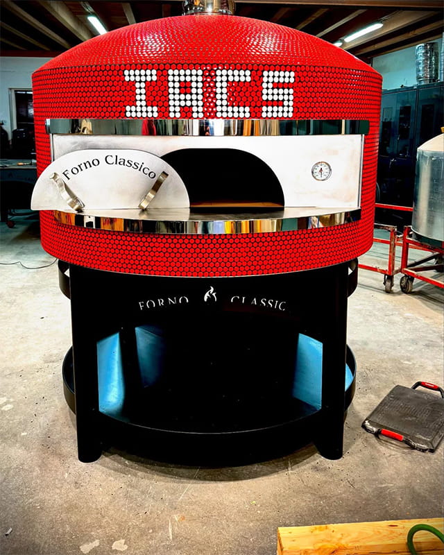 Forno Classico Colosso with a red tile pattern and a white tile pattern that spells "IACS" above the oven opening.